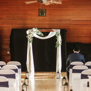 rows of chairs with white and blue sashes