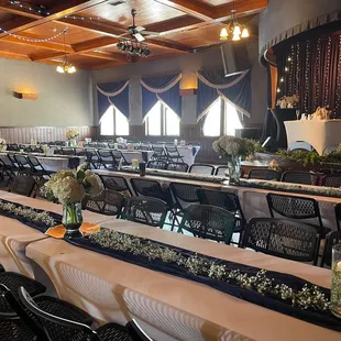rows of tables and chairs set up for a function