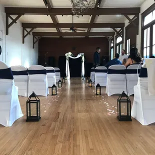 rows of white chairs with blue sashers