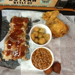Ribs and chicken with fried okra, baked beans and hush puppies.