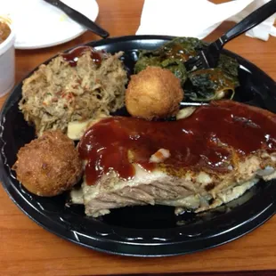 Ribs and pork BBQ with beans and collards.