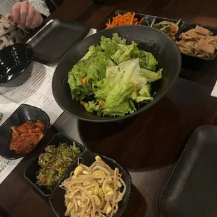 The banchan: spiced radish, sautéed veggies, fishcake, kimchi, baby anchovies, sautéed bean sprouts, and a salad