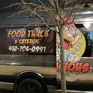 a food truck and a tree