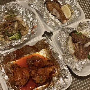 four trays of food on a table