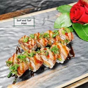 a plate of sushi and a rose