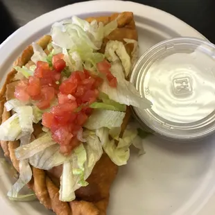 Small beef, bean, &amp; cheese sopapilla with side of sour cream.