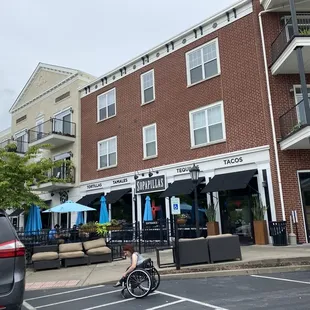 a man riding a bike in front of a restaurant