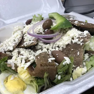 a salad in a styrofoam container