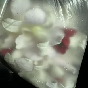 White orchid and red baby rose leis.