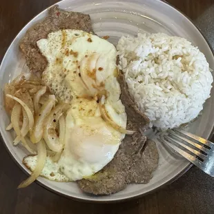 Steak and eggs with rice.