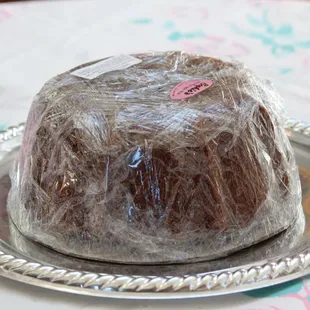 a chocolate cake wrapped in plastic