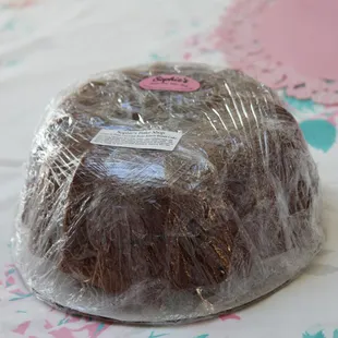 a chocolate cake wrapped in plastic