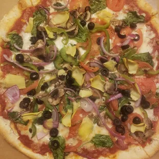 Veggie pizza with a ridiculous amount of added artichoke leaves that we paid extra for.