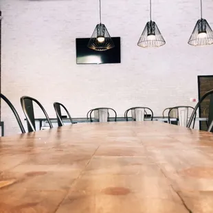 a long wooden table and chairs in a restaurant