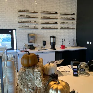 a kitchen counter with pumpkins on it