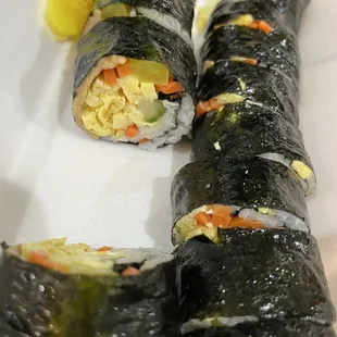 two pieces of sushi on a plate