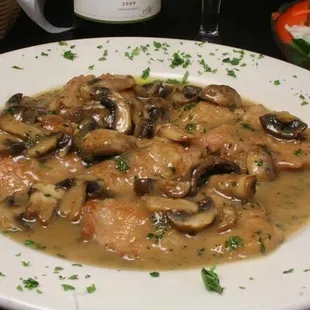a plate of chicken and mushrooms
