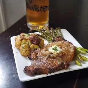 a plate of food and a glass of beer