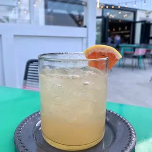 a glass of orange juice on a plate