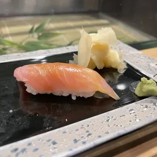 a sushi on a black plate