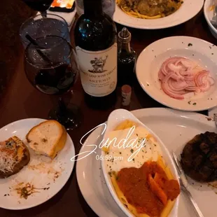 a table full of food and wine