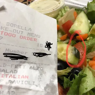 a salad in a styrofoam container