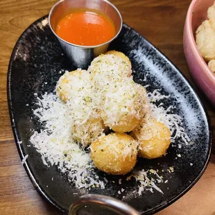 a plate of food and a bowl of sauce