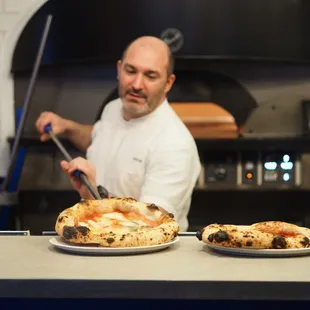 Chef Joe taking pizza straight from the oven to your table.