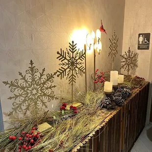 a table with candles and christmas decorations