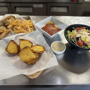 a bowl of fries and a salad