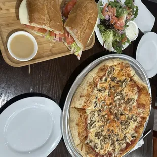 Pizza with a sub and salad