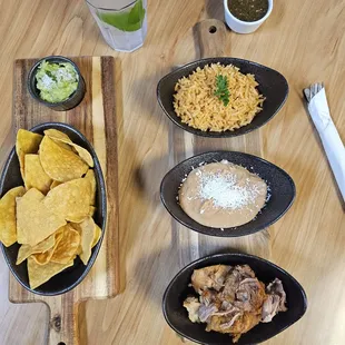 Slow cooked carnitas with refried beans Spanish rice