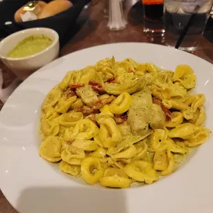 Tortellini with extra Pesto Sauce. I like to add sun dried tomatoes and artichokes to mine.