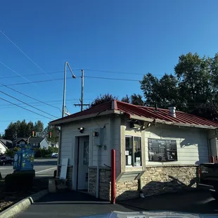 a small building with a red roof