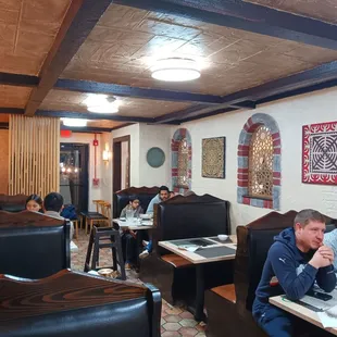 people sitting at tables in a restaurant