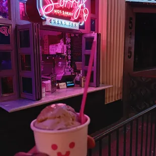 a hand holding a cup of ice cream