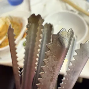gunked up food on the tongs