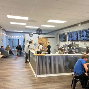people sitting at tables in a coffee shop