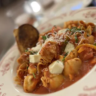 a plate of pasta with meat and cheese