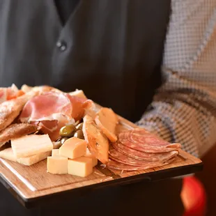 a man holding a platter of food