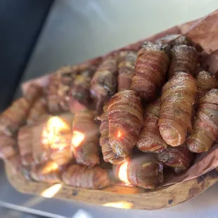 Armadillo eggs (jalapeño stuffed with cream cheese and brisket wrapped in three pieces of bacon.