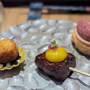 Tuna tartare and foie gras, australian wagyu with quail yolk, and cucumber and yaupon holly.
