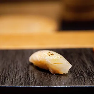 a sushi on a black plate