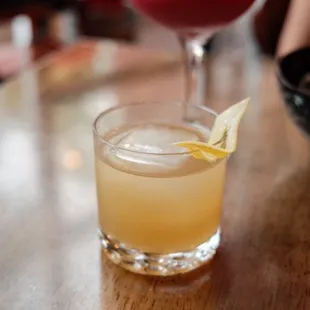 two cocktails on a wooden table