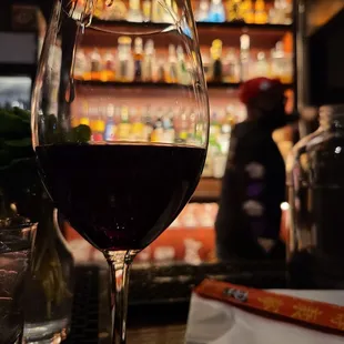 a glass of wine on a bar counter