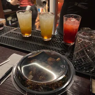 a person pouring a drink at a bar