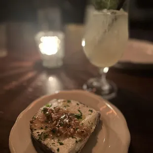 Whipped goat &amp; ricotta cheeses, honey, and hazelnuts.
 Amalfi cocktail in the background