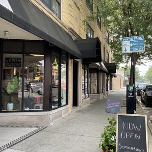 a sidewalk in front of a store