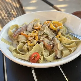 a bowl of pasta and a glass of wine