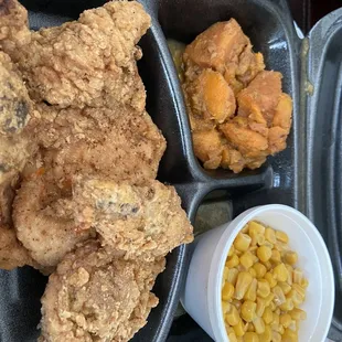 Fried pork chops with corn and sweet potatoes.